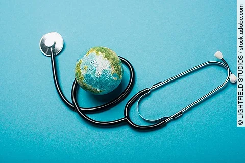 Weltkugel und Stethoskop auf blauem Hintergrund. 