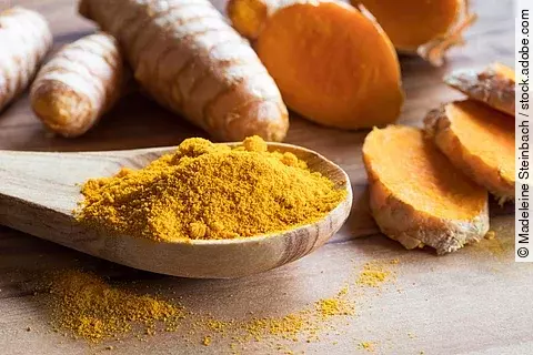 Kurkuma Pulver und frische Kurkumawurzel.