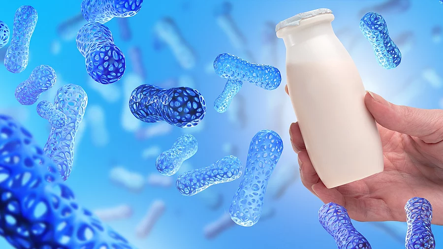 Illustration: blau eingefärbte Bakterien in blauem Umfeld, eine Hand hält ein Fläschchen mit Joghurt