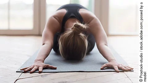 Frau auf Yogamatte, Kind-Asana