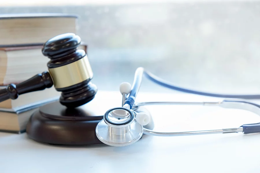 Gavel and stethoscope. medical jurisprudence. legal definition of medical malpractice. attorney. common errors doctors, nurses and hospitals make Richterhammer und Stethoskop