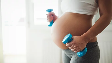 Pregnant woman taking care of her body during pregnancy