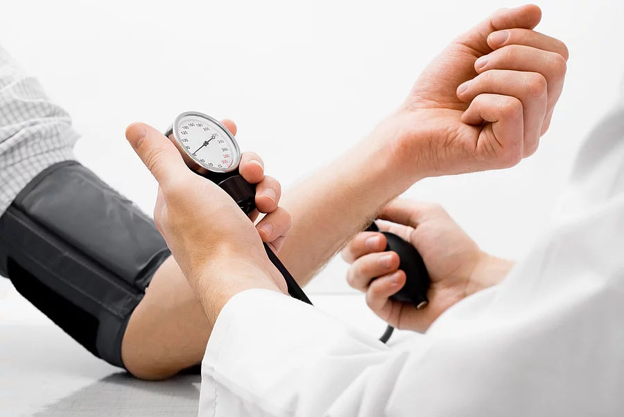 Blood pressure measuring studio shot Arzt misst Blutdruck an Frauenarm