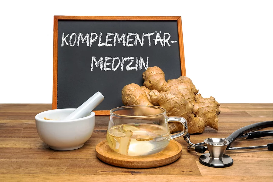 Ingwerknolle und Ingwertee, Tafel mit Aufschrift Komplementärmedizin