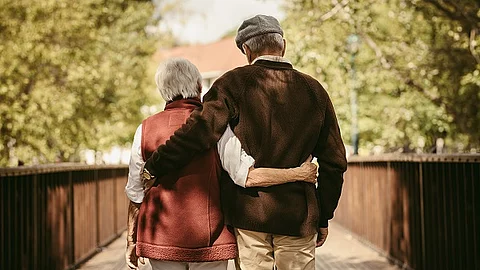 Senior couple walking through a park