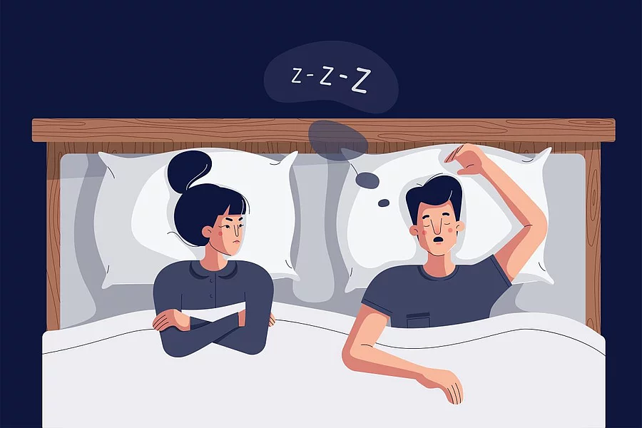 Cartoon-Zeichnung Frau liegt neben schnarchendem Mann im Bett und schaut zornig