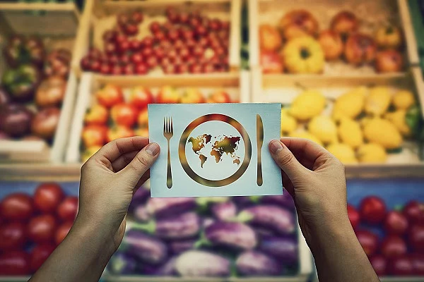 Globale Hungerproblematik vor einem Obst- und Gemüsehändler.